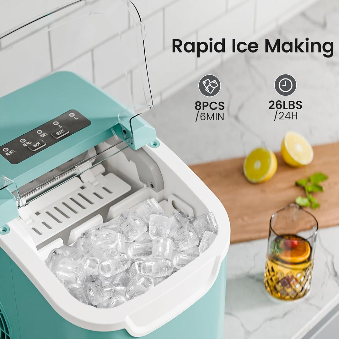 Teal ice maker with ice cubes on a kitchen counter, lemon slices, and a glass of juice.