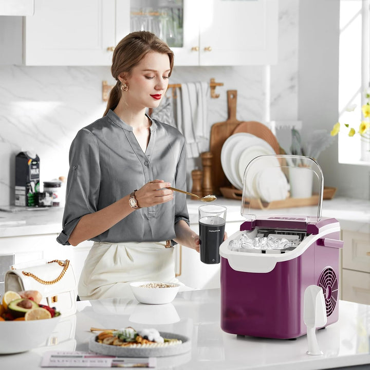 Woman in a kitchen with a purple ice maker and food items on the counter.