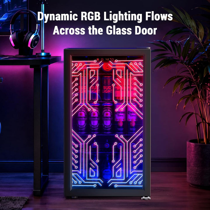 A glass-door beverage refrigerator with dynamic RGB lighting showing a circuit-board pattern in pink, purple, and blue, stocked with bottles. The text 'Dynamic RGB Lighting Flows Across the Glass Door' is overlaid at the top, and a desk with headphones and a potted plant are visible in a styled room setting.