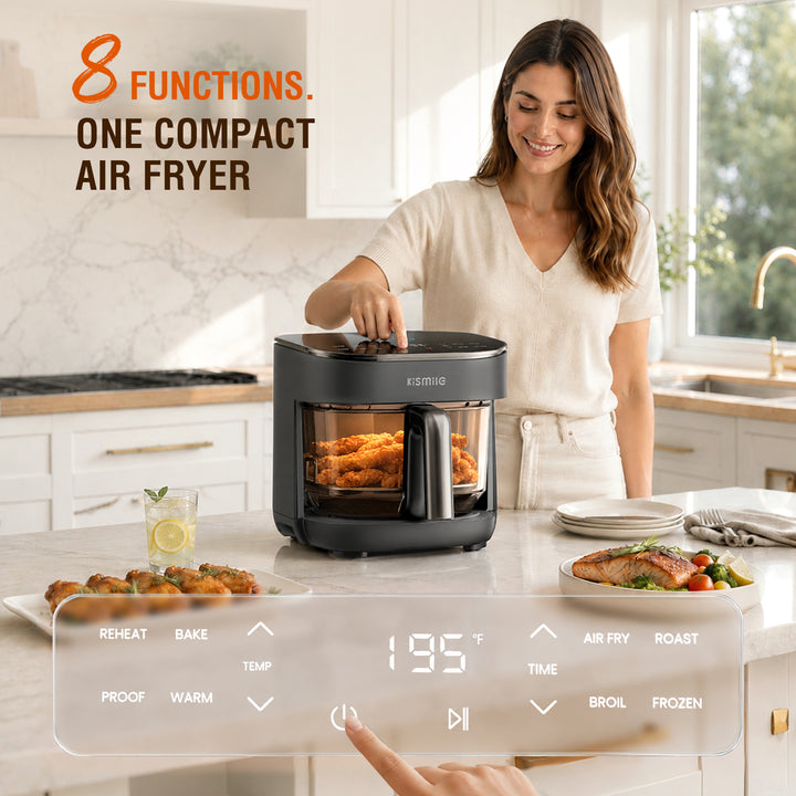 A woman in a bright kitchen uses a compact black air fryer with a transparent window, showing cooked chicken inside. The image includes promotional text reading '8 FUNCTIONS.