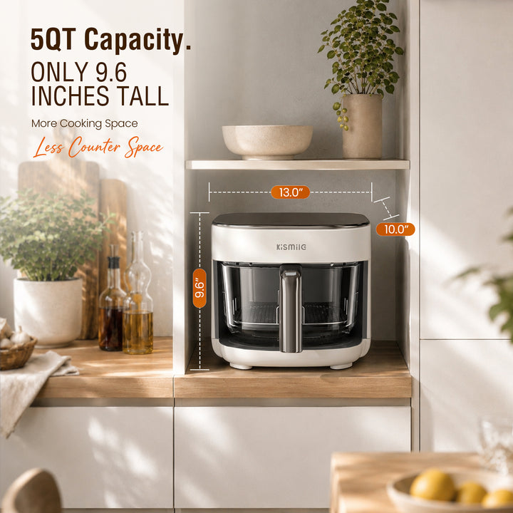 A countertop electric kettle or tea infuser shown in a styled kitchen setting with measurement callouts indicating 9.65 inches width, 9.