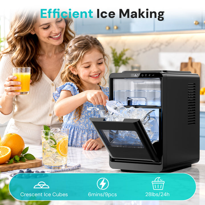A black countertop ice maker shown in a bright kitchen setting, with a woman and child smiling beside it. The machine door is open, and ice cubes are visible inside.