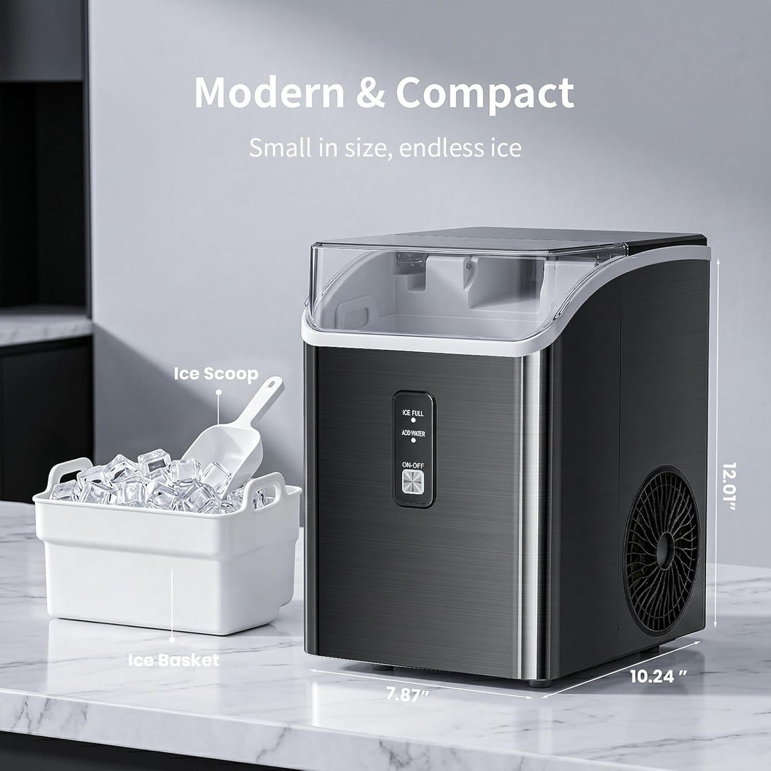 Compact ice maker with ice scoop and basket on a marble countertop