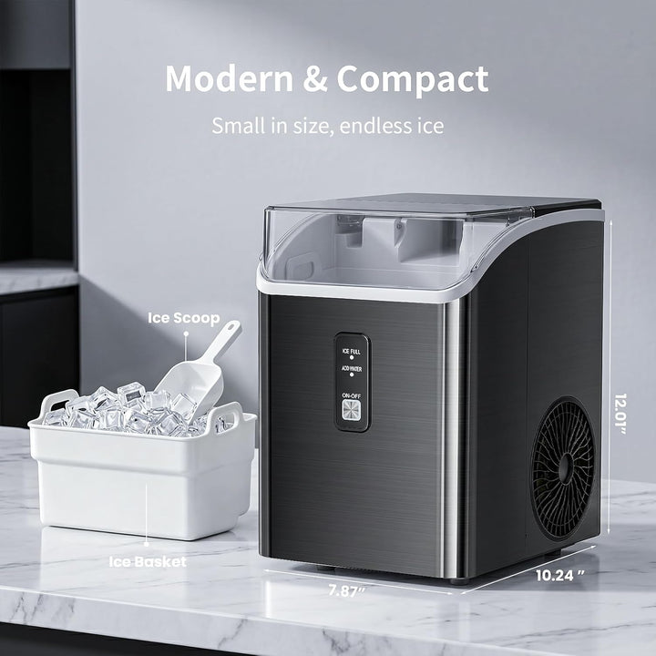 Compact ice maker with ice scoop and basket on a marble countertop