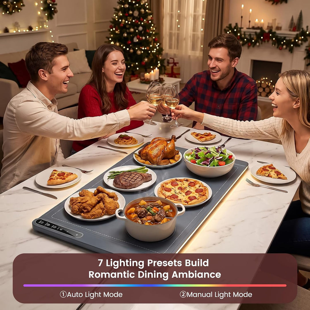 Four people celebrating around a dining table with a multi-zone electric heating pad under glowing food and warm ambient lights. The scene includes a Christmas tree, fireplace, and a text banner at the bottom describing lighting presets.