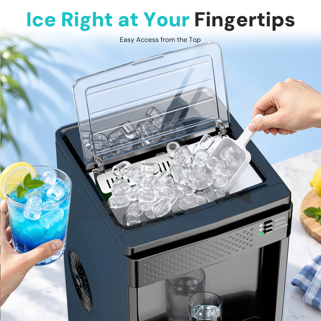 A countertop ice maker shown with a clear lid open, filled with ice cubes, and a hand using a white scoop to add more ice. A hand also holds a blue drink with a lemon garnish.