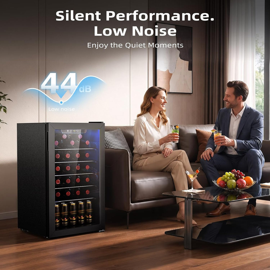 A black under-counter wine refrigerator with a glass door stands in a modern living room next to a sofa, with a man and woman sitting on the couch. Text overlays read 'Silent Performance.